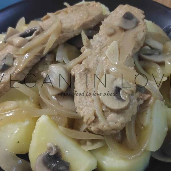 Plant-based chicken with mushrooms and onions