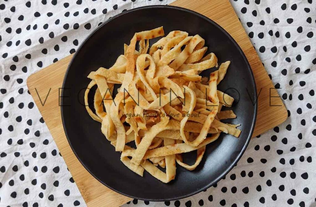 Comforting, rich, and filling vegan crepes tagliatelle. Enjoy this homemade and delicious savory crepe recipe with a tasty mushroom tomato and bechamel sauce.