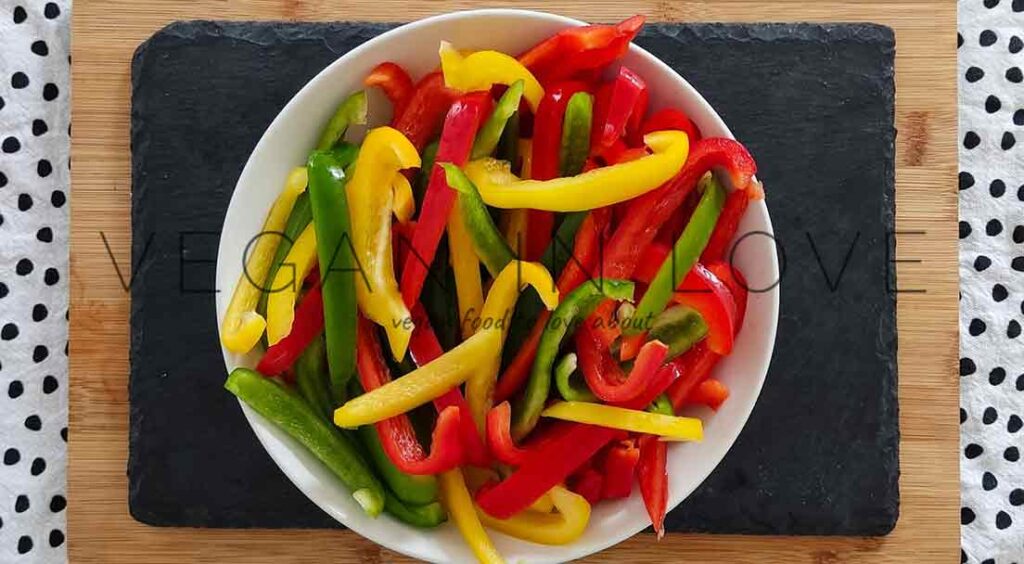 This delicious side dish is super easy and simple to make. Enjoy these sauteed peppers and onions as a great side dish together with vegan burgers and more!